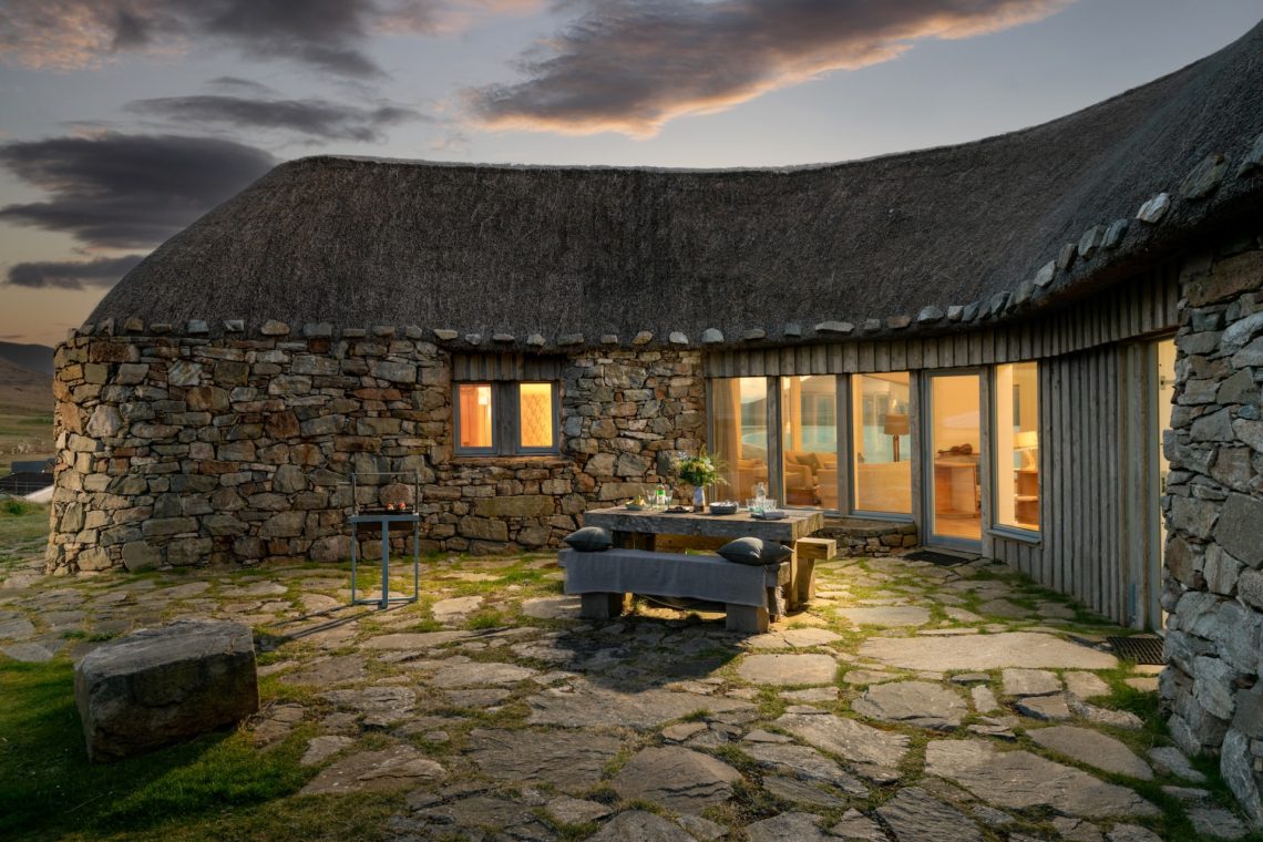 orana na mara courtyard image stone walls and thatch roof