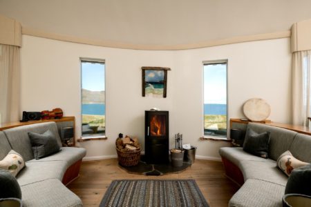 bright open living room with views of isle of harris and cetral fire place
